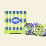 Two rolls and a box of Who Gives a Crap large recycled bin bags with green and blue packaging