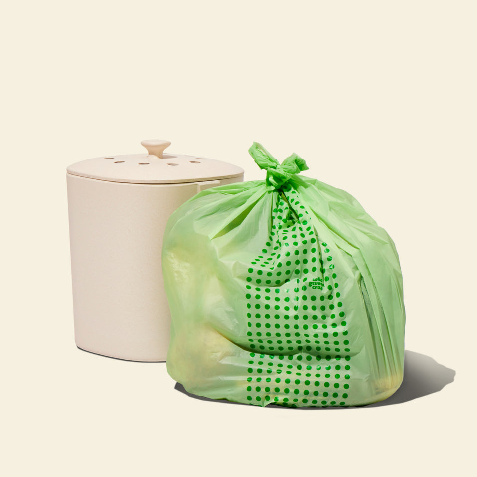 Two rolls and a box of Who Gives a Crap compostable rubbish bags with green packaging