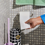 Hand reaches to use Who Gives a Crap bamboo toilet paper