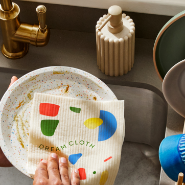 Hand washing a dish with a soft swedish dish cloth.