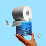 Hand holding a roll of toilet paper with a blue patterned wrapped roll on a light blue background