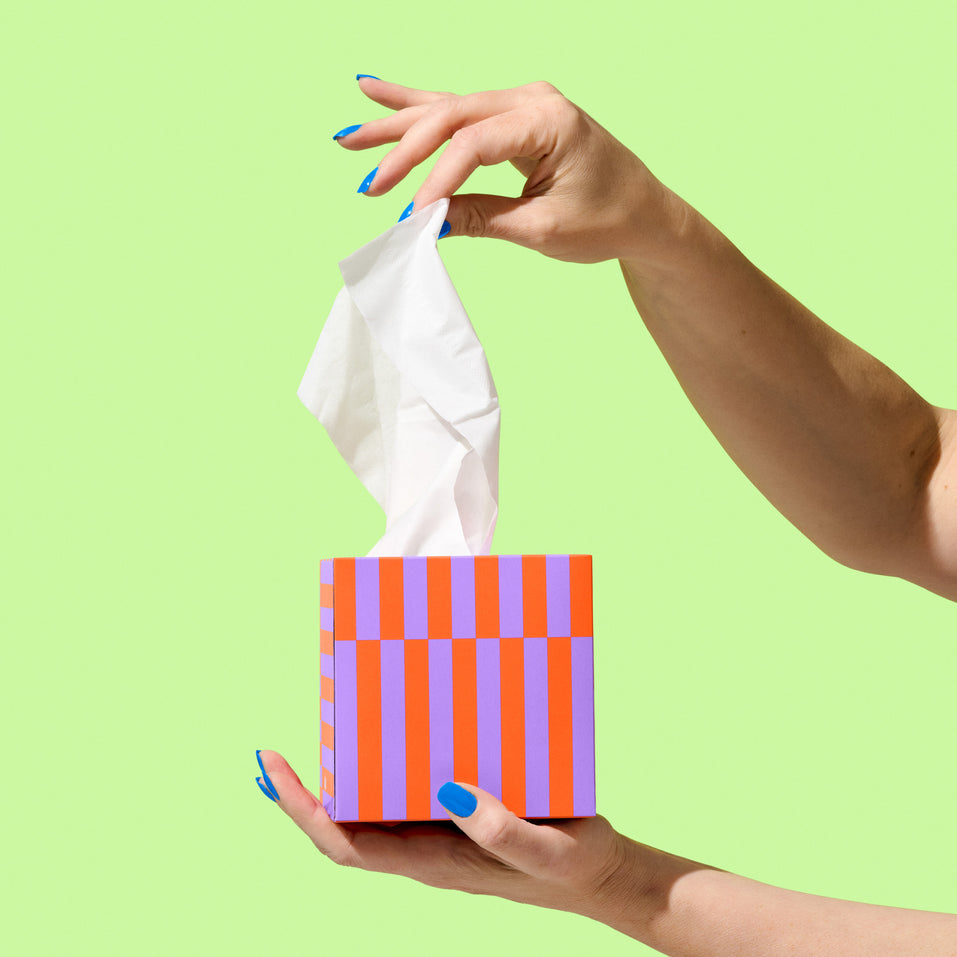 Hand pulling Recycled tissue out of tissue box