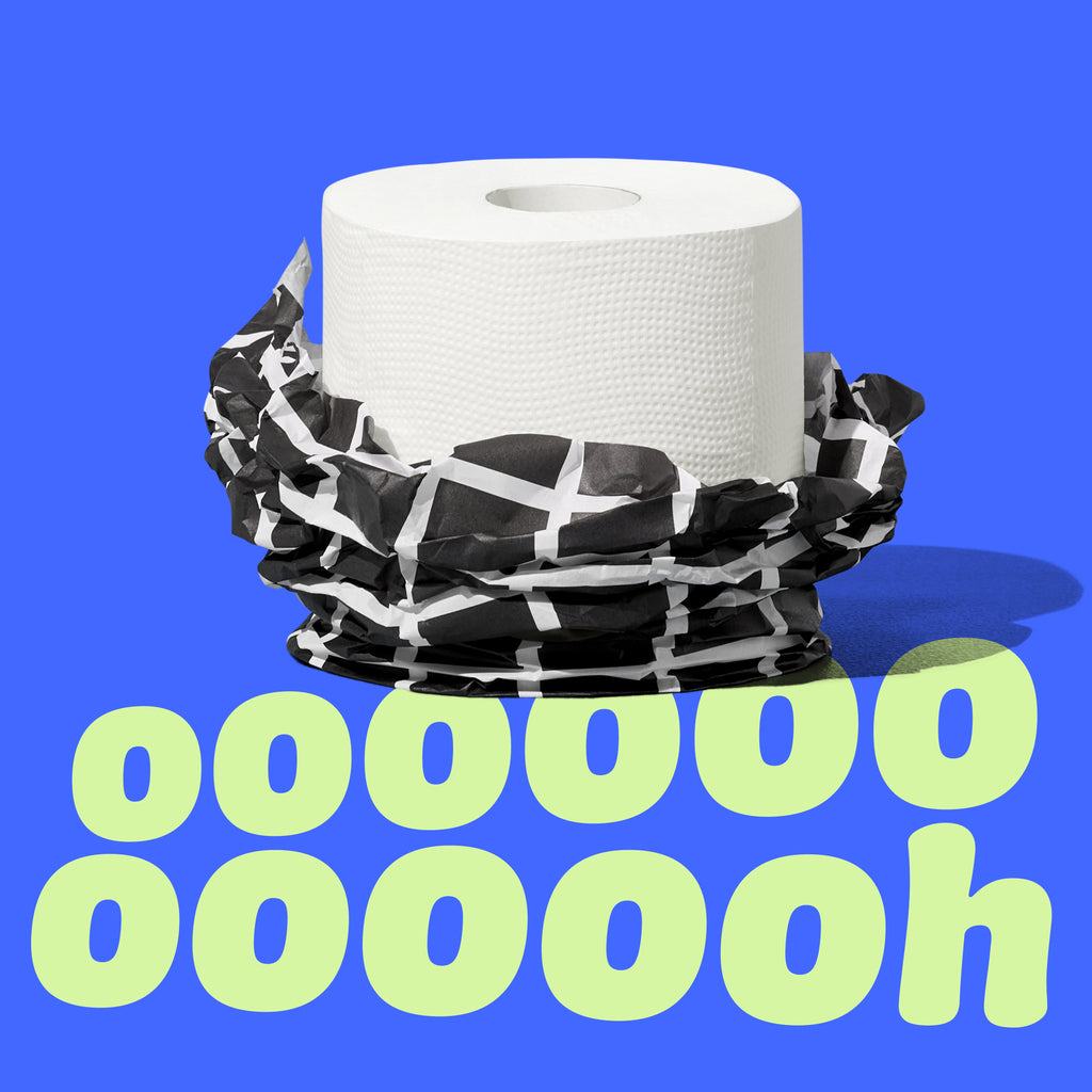 Single roll of Who Gives a Crap bamboo toilet paper with it's paper packaging half unwrapped