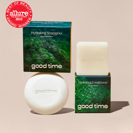 Naked Good Time Shampoo and Conditioner bars are displayed next to their packaging with an Allure Best of Beauty award.
