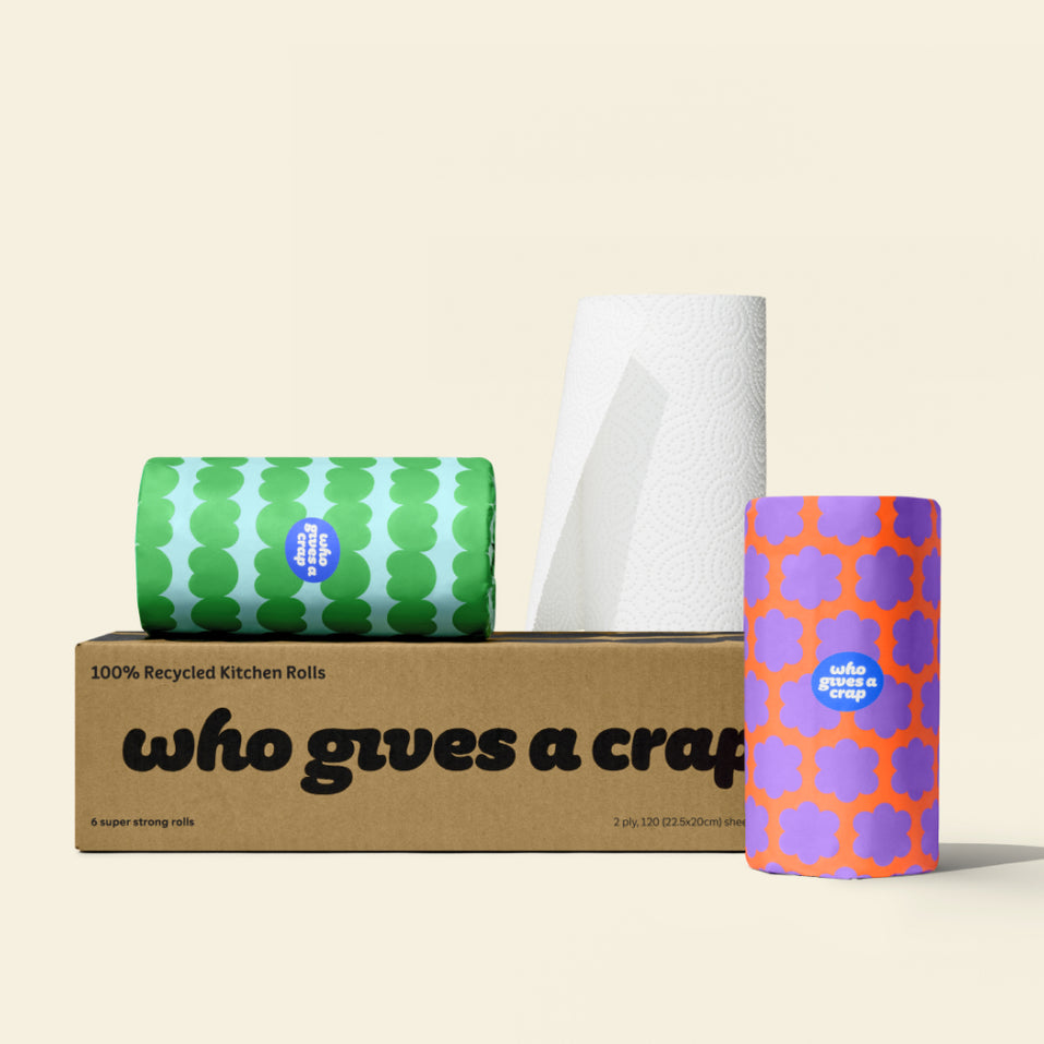 Box of six Who Gives a Crap kitchen roll with two rolls wrapped in colourful packaging sitting on top.