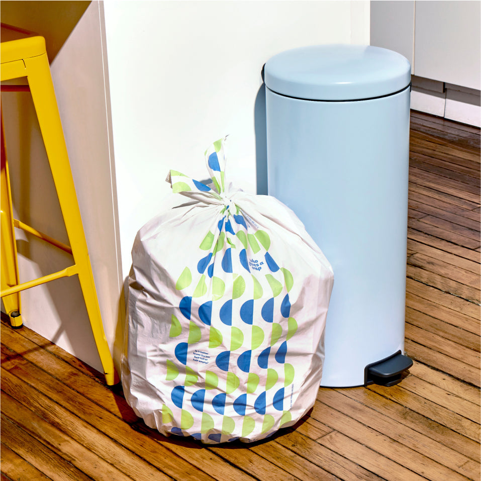 Who Gives a Crap large recycled bin bag sits full next to kitchen bin.