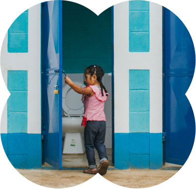 Young child opening door to bathroom cubicle