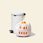 Who Gives a Crap large recycled bin bag sits full next to kitchen bin